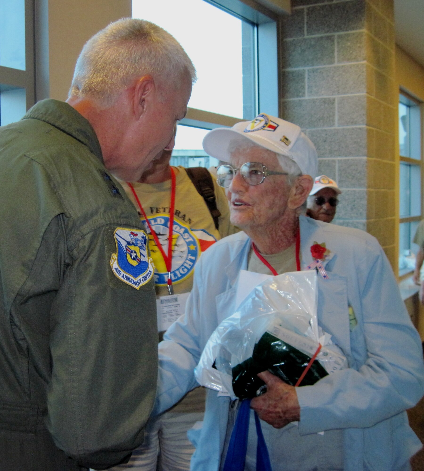Maj. Gen. C.R. Davis, Air Armament Center commander, greets veterans as they make their way off the plane at Northwest Florida Regional Airport May 5. One hundred World War II veterans visited Washington D.C. as part of the community's annual Honor Flight. (U.S. AIr Force photo/Maj. Gregory B. Harland)