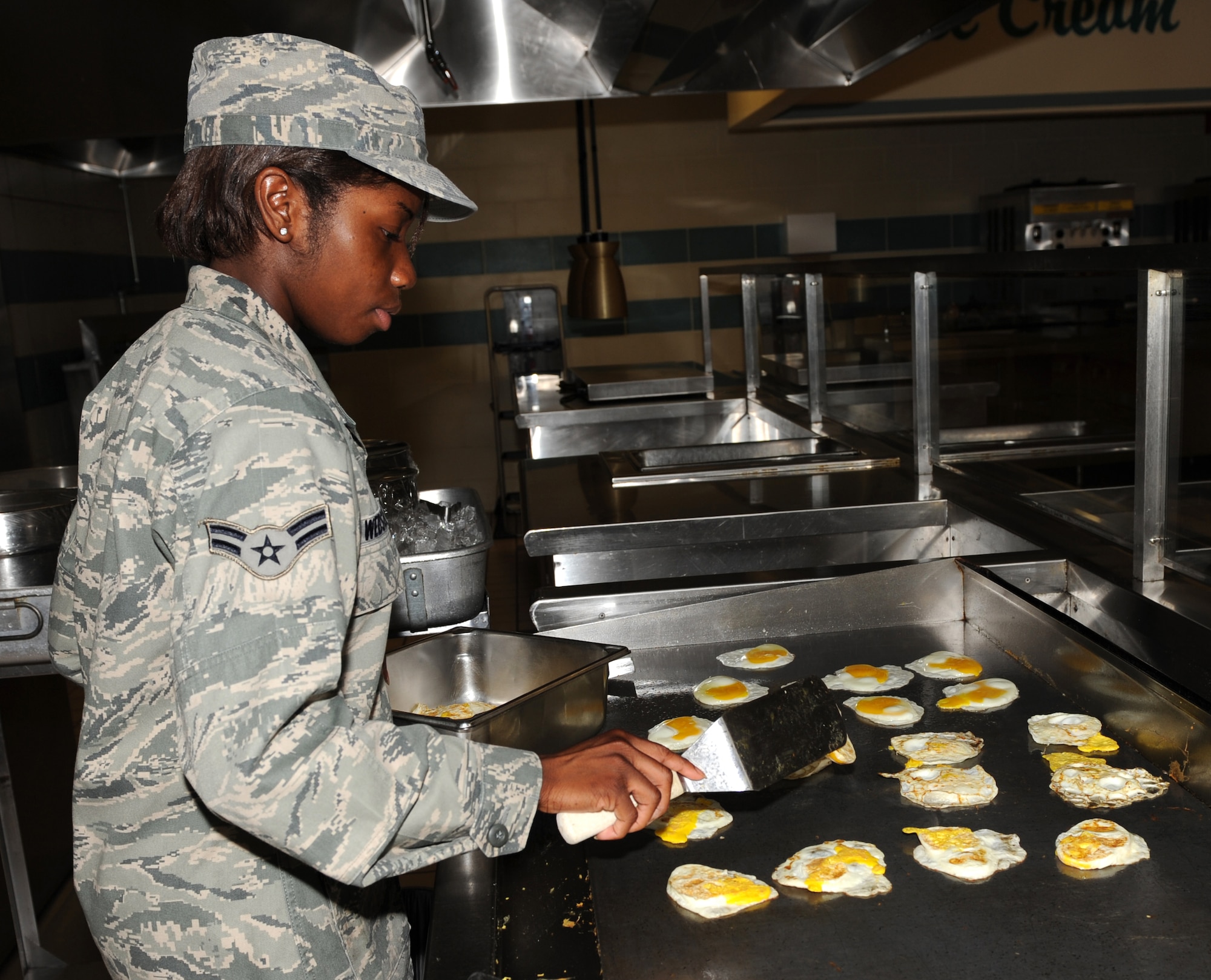 SEYMOUR JOHNSON AIR FORCE BASE, N.C. -- Airman 1st Class Emantranette Webster fries eggs at the Southern Eagle Dining Facility here May 6, 2010. She used the eggs to make breakfast croissant sandwiches. Airman Webster, 4th Force Support Squadron services apprentice, hails from Ocala, Fla. (U.S. Air Force photo/Airman 1st Class Gino Reyes)