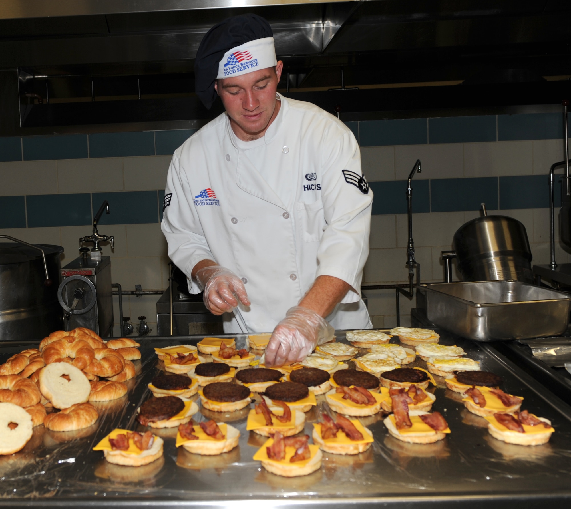 SEYMOUR JOHNSON AIR FORCE BASE, N.C. -- Senior Airman Adam Hicks prepares breakfast croissants at the Southern Eagle Dining Facility May 6, 2010. The dining facility staff begins cooking at 5 a.m. to provide a healthy breakfast for base Airmen, retirees and civilian employees. Airman Hicks, 4th Force Support Squadron services technician, hails from Sydney, Ohio. (U.S. Air Force photo/Airman 1st Class Gino Reyes)