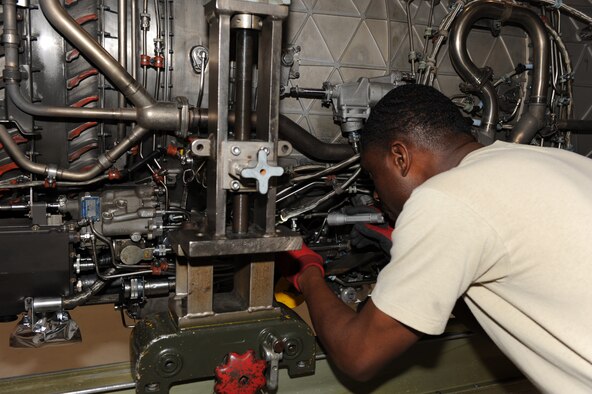 SEYMOUR JOHNSON AIR FORCE BASE, N.C. -- Staff Sgt. Michael Walton inspects an F-100-220E jet engine, May 5, 2010. When an engine is sent from the flightline, it is inspected by an engine specialist to pinpoint the problem before the engine is broken down and repaired. Sergeant Walton, 4th Component Maintenance Squadron jet engine mechanic, hails from Augusta, Ga. (U.S. Air Force photo/Airman 1st Class Gino Reyes)