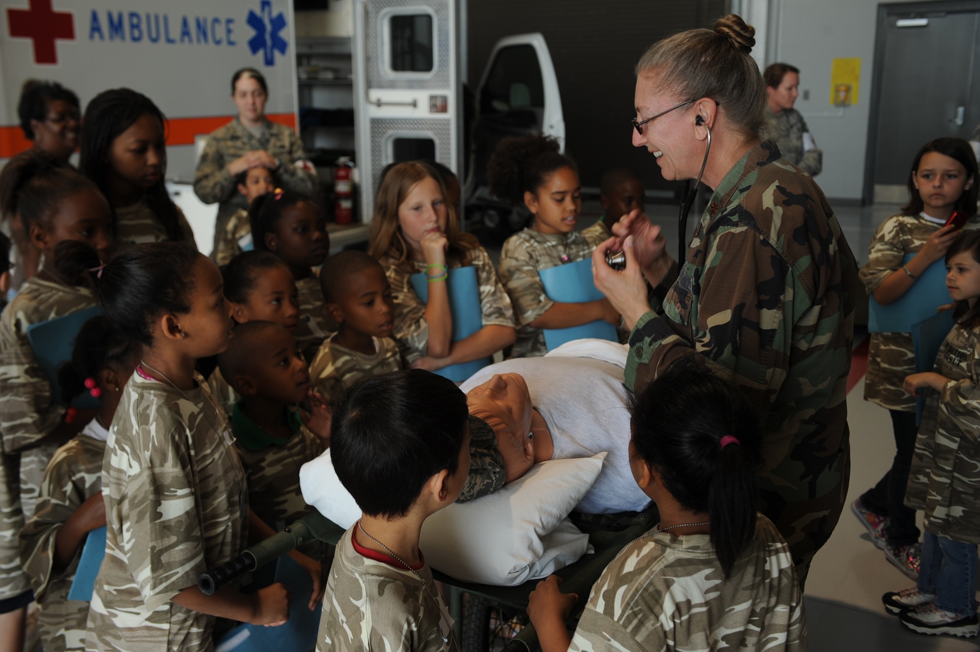 SEYMOUR JOHNSON AIR FORCE BASE, N.C. -- Maj. Kathy Martin explains the role of nurses and other medical personnel to children participating in Operation Bug Out April 30, 2010. The children met at the youth center, where they were issued their uniform of the day and dog tags before taking the oath of enlistment. Major Martin, 4th Aerospace Medicine Squadron nurse manager of flight medicine, hails from Perry, Maine. (U.S. Air Force photo/Senior Airman Ciara Wymbs) 
