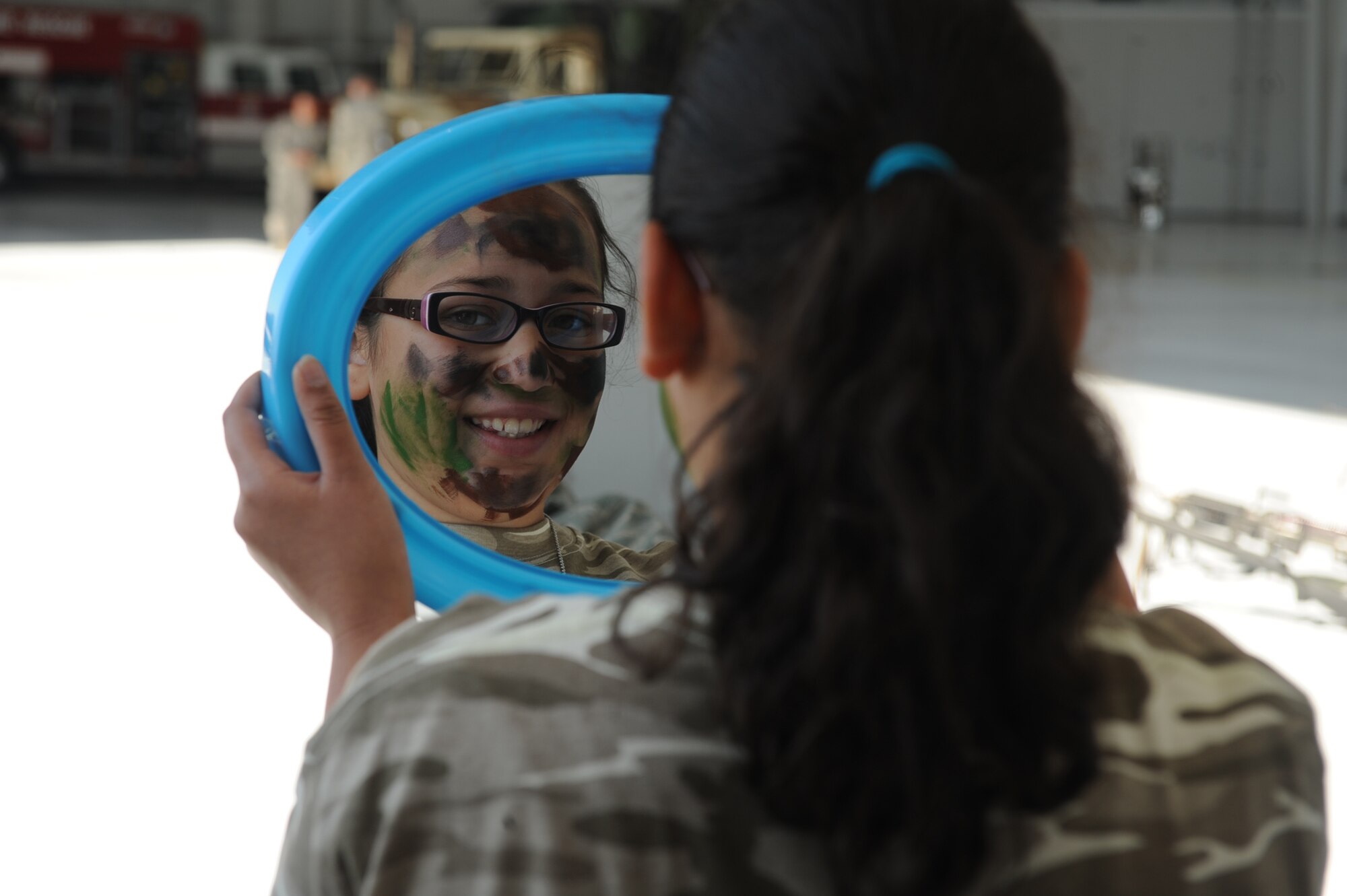 SEYMOUR JOHNSON AIR FORCE BASE, N.C. -- Sadie Chandler, 9, checks out her camouflaged reflection during Operation Bug Out April 30, 2010. Operation Bug Out gave children the opportunity to experience what their parents go through while deployed. Sadie is the daughter of Master Sgt. Keri Chandler, 4th Aerospace Medicine Squadron deployment medicine NCOIC. (U.S. Air Force photo/Senior Airman Ciara Wymbs) 
