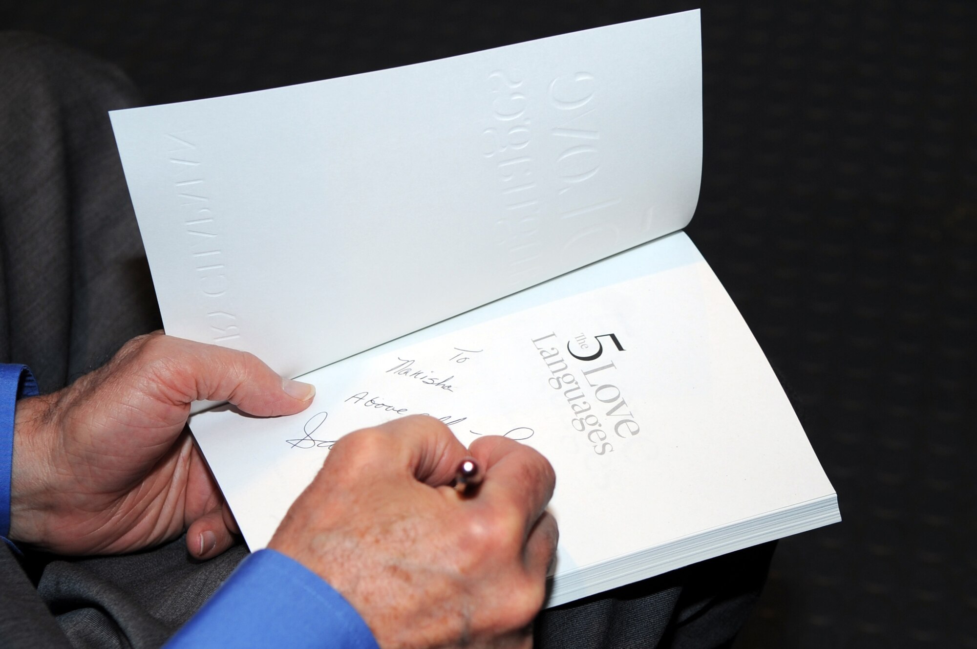 SEYMOUR JOHNSON AIR FORCE BASE, N.C. -- Author Gary Chapman autographs his best-selling book "The Five Love Languages" during a marriage retreat here, May 4, 2010. During the retreat Mr. Chapman discussed the love and apology languages, understanding and handling anger, and how to overcome long-term anger. Dr. Chapman hails from Winston Salem. (U.S. Air Force photo/Staff Sgt. Courtney Richardson)