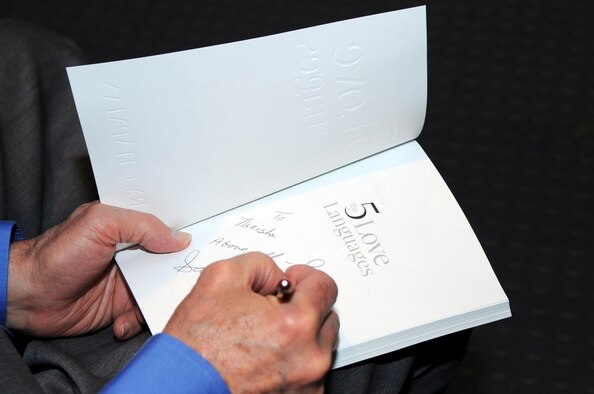 SEYMOUR JOHNSON AIR FORCE BASE, N.C. -- Author Gary Chapman autographs his best-selling book "The Five Love Languages" during a marriage retreat here, May 4, 2010. During the retreat Mr. Chapman discussed the love and apology languages, understanding and handling anger, and how to overcome long-term anger. Dr. Chapman hails from Winston Salem. (U.S. Air Force photo/Staff Sgt. Courtney Richardson)