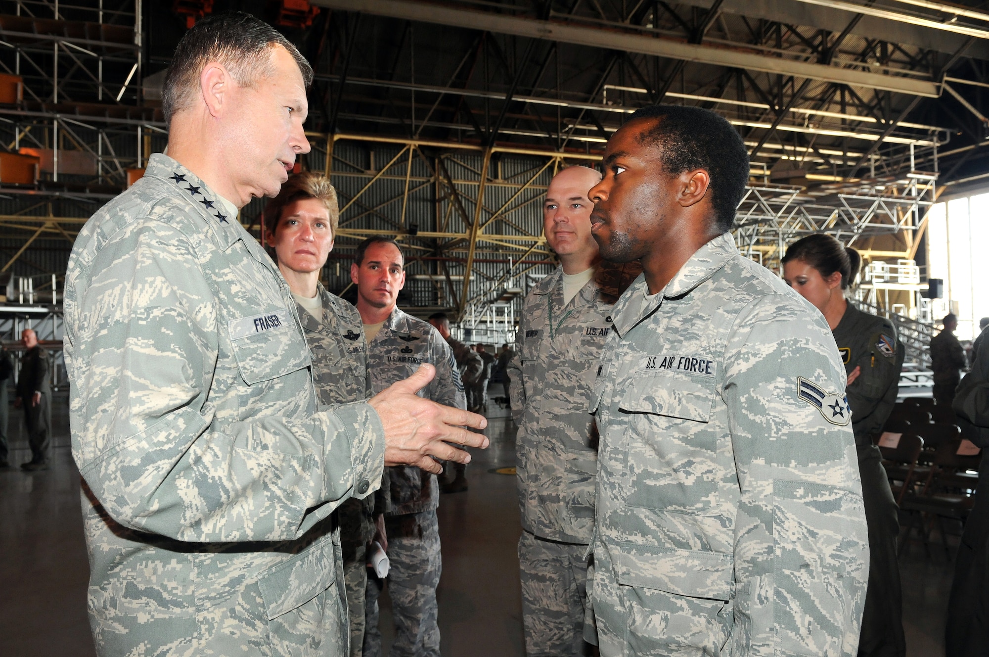 Gen. William M. Fraser III, commander of Air Combat Command, answers a question from Airman 1st Class Jonathan Wilson, 552nd Aircraft Maintenance Squadron, as Col. Patricia Hoffman, 552nd ACW commander; Command Chief Master Sgt. Scott Magoon; and 552nd AMXS first sergeant, Master Sgt. Brian Brewer look on. (Air Force photo by Dave Faytinger)