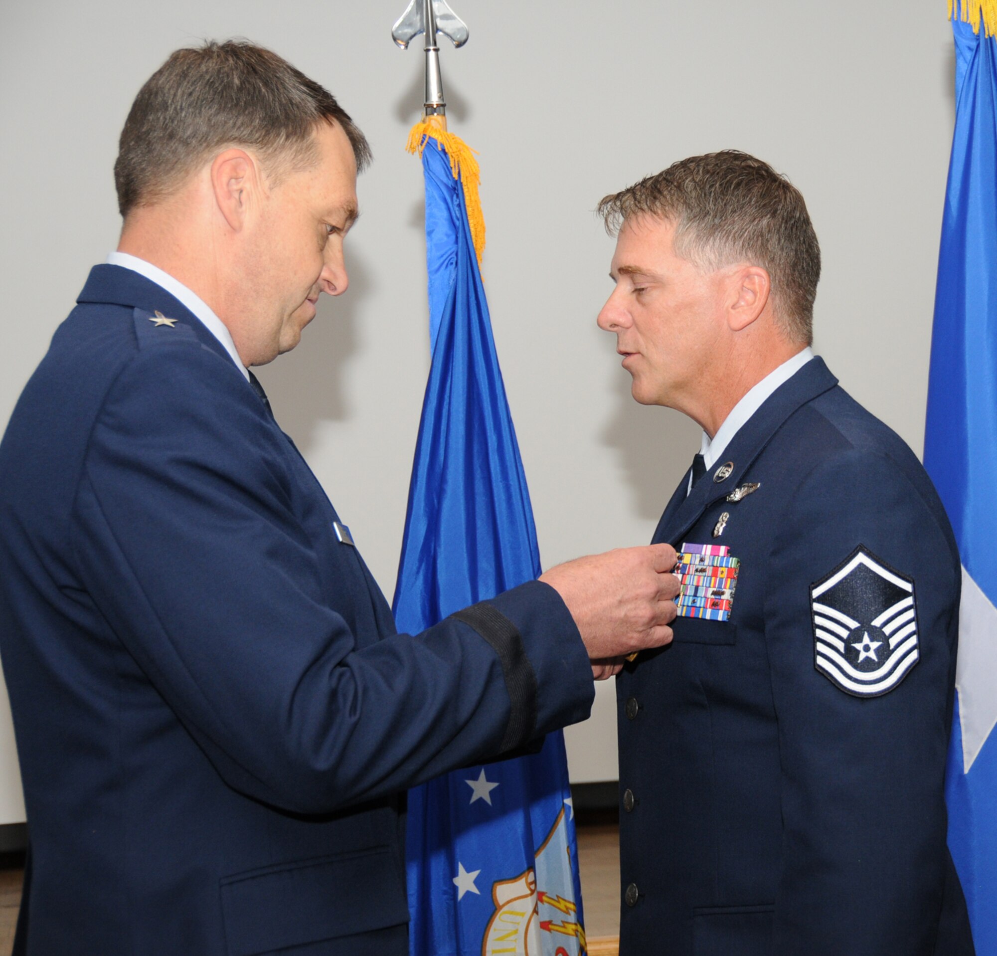 Brig. Gen. Kory Cornum, 81st Medical Group commander, pins Master Sgt. Kenneth Gestring with the Purple Heart at a May 4 ceremony at Keesler Medical Center.  Sergeant Gestring, 81st Surgical Operations Squadron, received the award for wounds he suffered in January in Afghanistan.  (U.S. Air Force photo by Kemberly Groue)