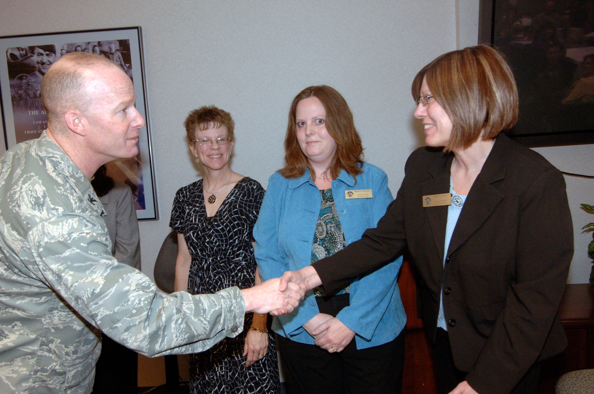 SCOTT AIR FORCE BASE, Ill. -- Col. Gary Goldstone, 375th Air Mobility Wing commander, shakes hands with members of the Airman and Family Readiness thanking them for all the hard work they have put into the key spouse program. Scott AFB has 120 Key Spouses and Key Spouse mentors, who serve as another layer for commander’s to connect with their Airmen and families. Key Spouses also help ensure families know how to navigate and understand the numerous programs and benefits available to them. Photo by Karen Petitt

