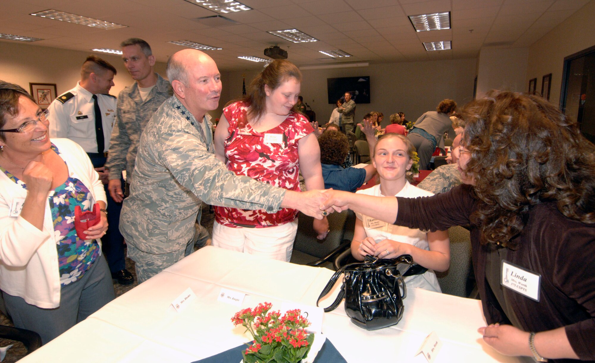 SCOTT AIR FORCE BASE, Ill. -- Gen. Duncan and Linda McNabb extend their personal thanks during an appreciation luncheon April 29 to those who have volunteered the past year as Key Spouses.  Scott AFB has 120 Key Spouses and Key Spouse mentors, who serve as another layer for commander’s to connect with their Airmen and families. Key Spouses also help ensure families know how to navigate and understand the numerous programs and benefits available to them.  General McNabb serves as the commander, U.S. Transportation Command and he and his wife have been staunch advocates of the Key Spouse program. Photo by Karen Petitt
