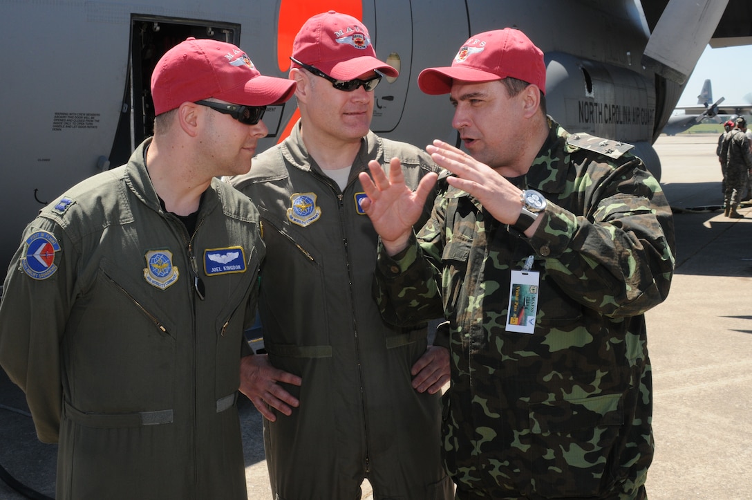 Col. Kozyrkov Ihor of the Ministry of Defense of Ukraine discusses flying the MAFFS mission with North Carolina Air National Guard pilots Lt. Col. Mark Christen and Capt. Joel Kingdon during the MAFFS training exercise in Greenville, SC. 