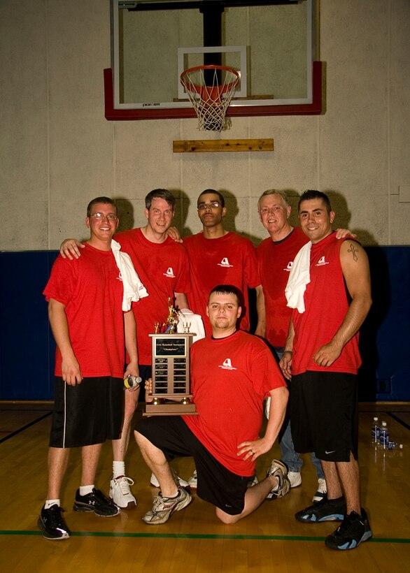 GRISSOM AIR RESERVE BASE, Ind. -- Members of the 'Cops' basketball team pose for a photo with their championship trophy after coming back from a 12-point deficit to beat 'The Marines,' earning them the title. (U.S. Air Force photo/Tech. Sgt. Mark R. W. Orders-Woempner)