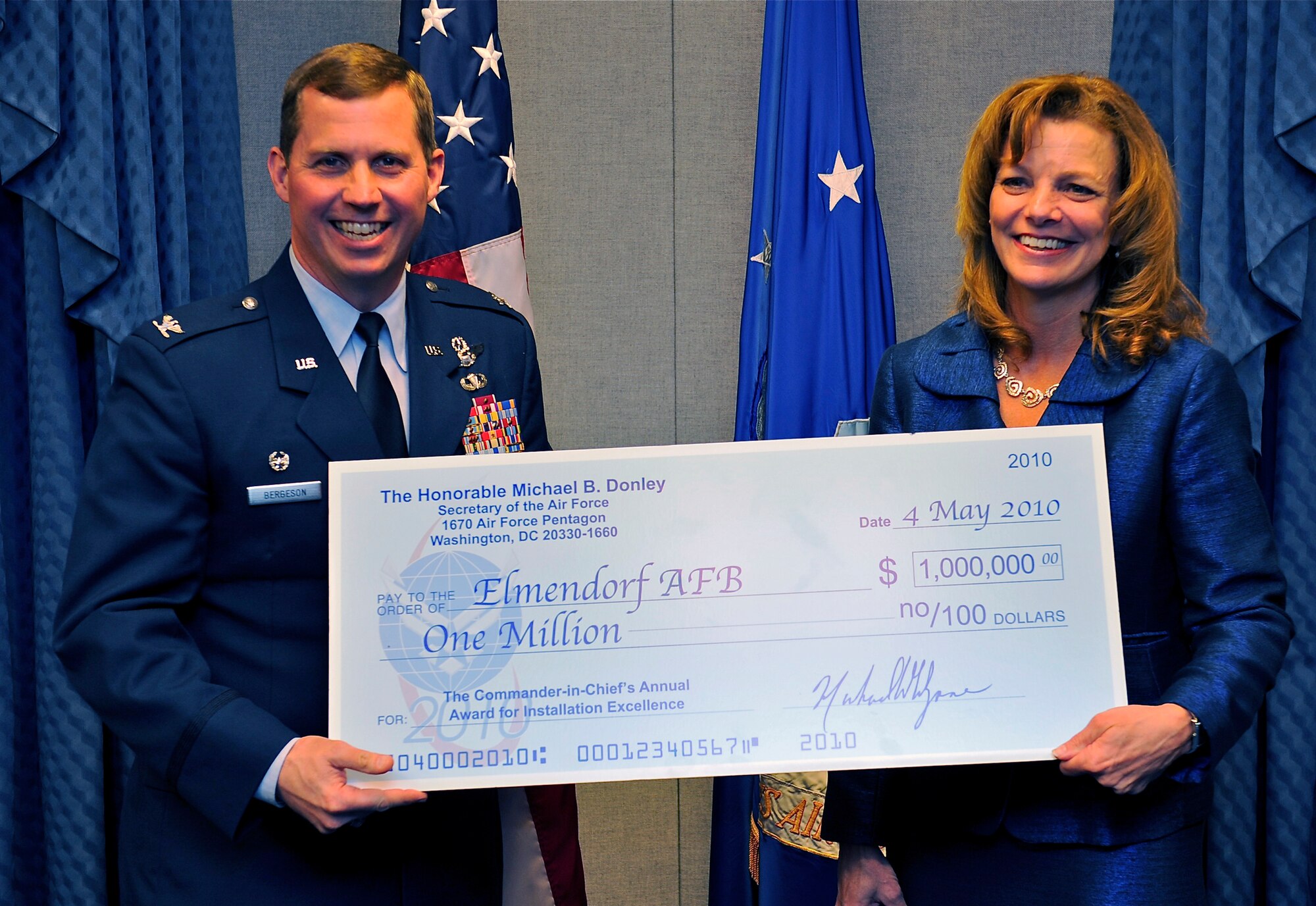 WASHINGTON -- Debra K. Tune, office of the Assistance Secretary of the Air Force for Installations, Environment and Logistics, presents Col. Thomas Bergeson, 3rd Wing commander, with a check for $1 million May 4.  The money is part of the 2010 Commander-in-Chief's Annual Award for Installation Excellence. (Air Force photo by Staff Sgt. Brian Ferguson)