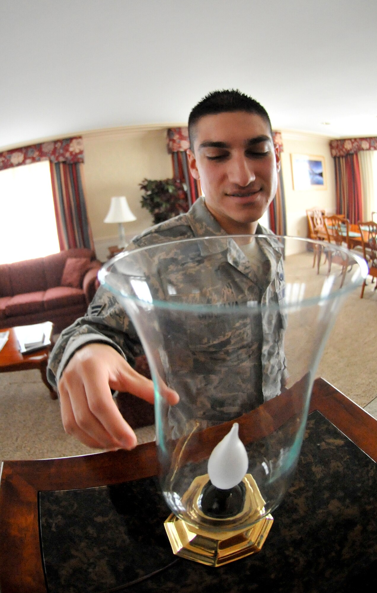 ELMENDORF AIR FORCE BASE, Alaska – Senior Airman Ramon Grijalva, 3rd Wing Protocol, checks a light to ensure it’s functioning properly during an Elmendorf chateau inspection April 30. Last summer Elmendorf’s protocol was recognized as one of the busiest protocol office in the Air Force. (Air Force photo by Airman 1st Class Christopher Gross)  