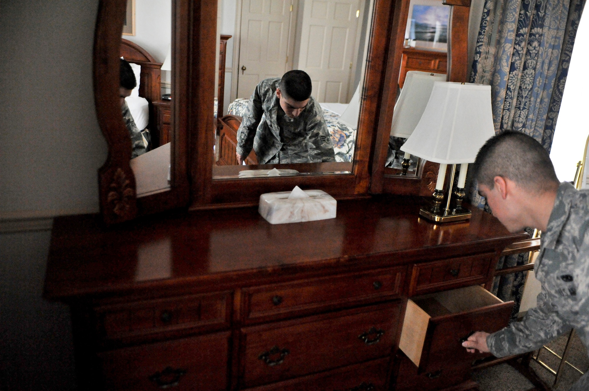 ELMENDORF AIR FORCE BASE, Alaska – Senior Airman Ramon Grijalva, 3rd Wing Protocol, inspects the inside of drawers during an Elmendorf  chateau inspection April 30. Last summer Elmendorf’s protocol was recognized as one of the busiest protocol office in the Air Force. (Air Force photo by Airman 1st Class Christopher Gross)  