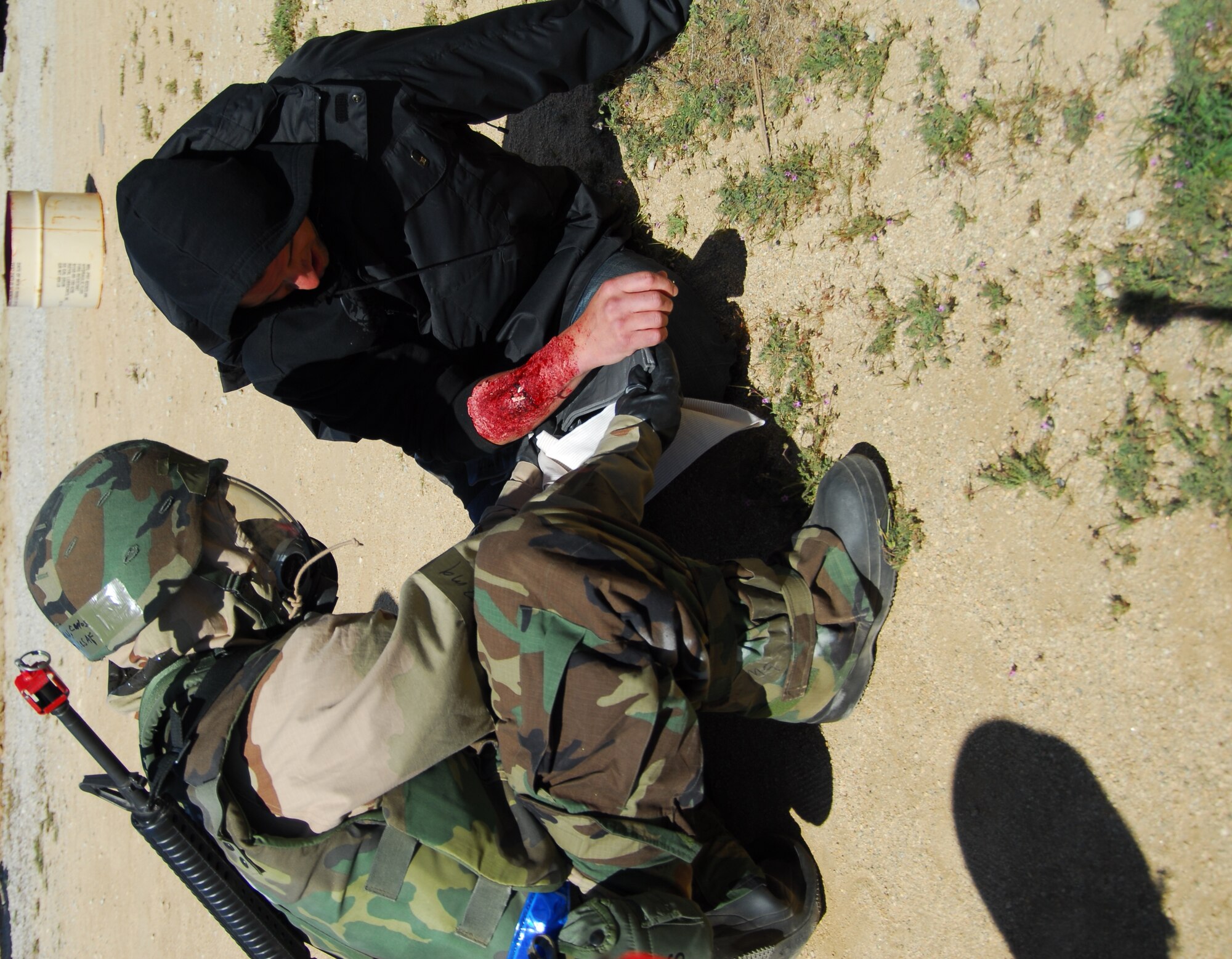 (Air Force photo by Stephen K. Robinson)

Moulage is used here to simulate a compound fracture to the lower right arm.  Medical personnel from the 95th Medical Group, dressed in MOPP Level 4, respond by treating this simulated injury in preparation for transportation.