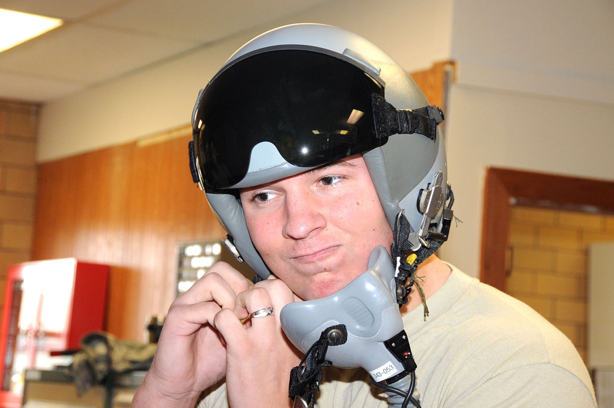 OFFUTT AIR FORCE BASE, Neb. -- Airman Devin Williams, an aircrew flight equipment technician with the 55th Operations Support Squadron, tests an HGU-55P (flyer's helmet) for a proper fit here April 29. The helmet is tested for normal and high altitudes before aircrews here deploy. U.S. Air Force Photo by Kendra Williams