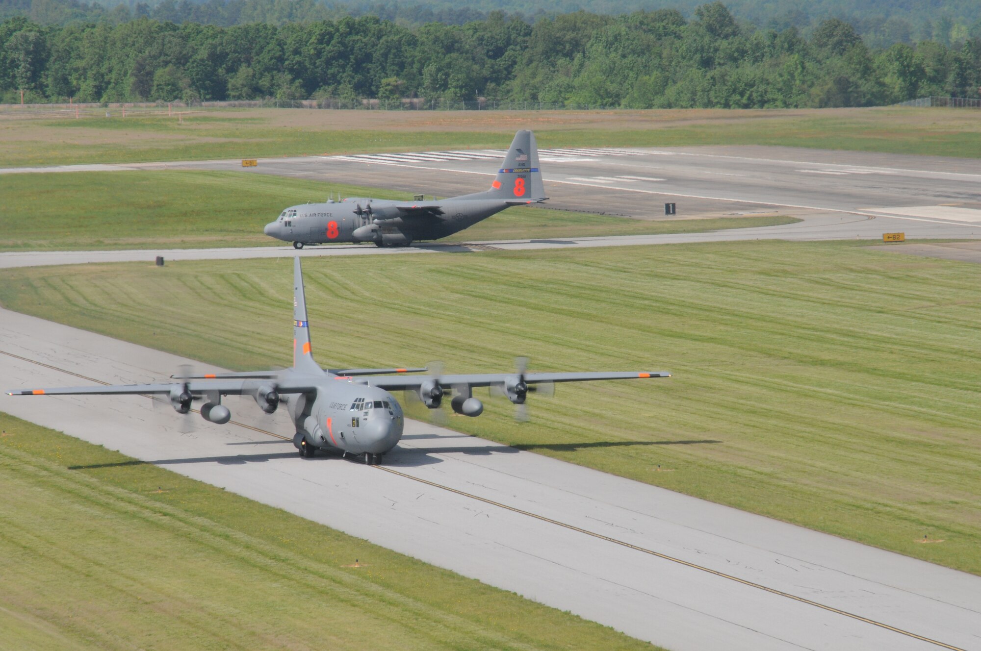 Aircraft from the North Carolina Air National Guard MAFFS seven taxies onto the runway to take-off to perform another MAFFS training mission, while MAFFS eight taxies in for another round of servicing and reloading before returning to the sky in Greenville, SC. Photo by Staff. Sgt. Richard Kerner
