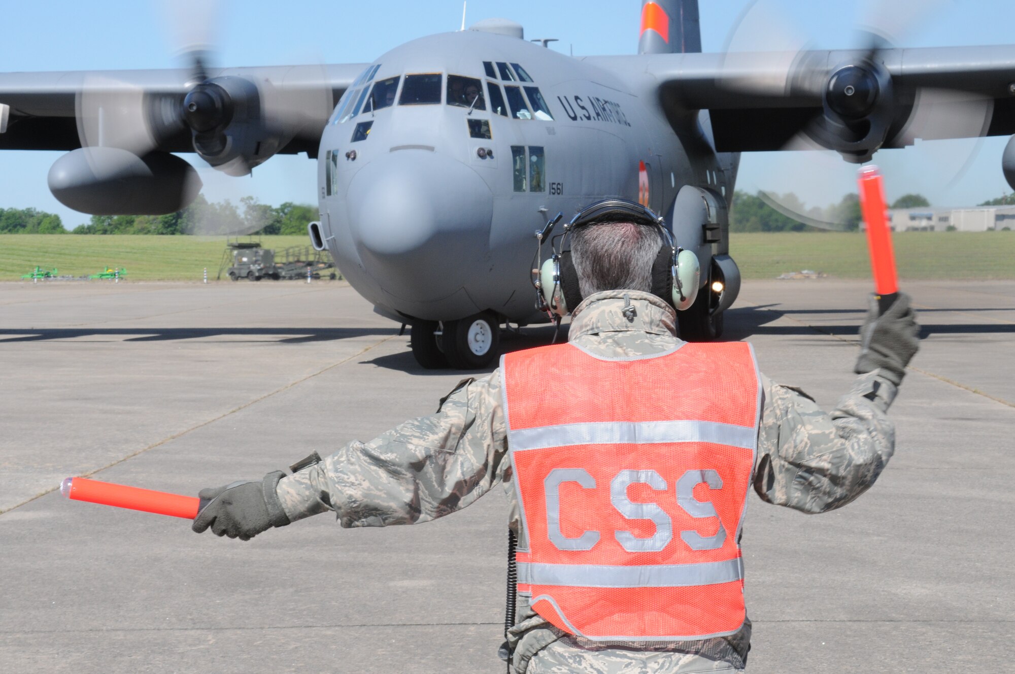 Master Sgt. Shawn Crisco marshals aircraft MAFFS eight out to perform another MAFFS training mission after it is serviced and reloaded in Greenville, SC. Photo by Staff Sgt. Richard Kerner.