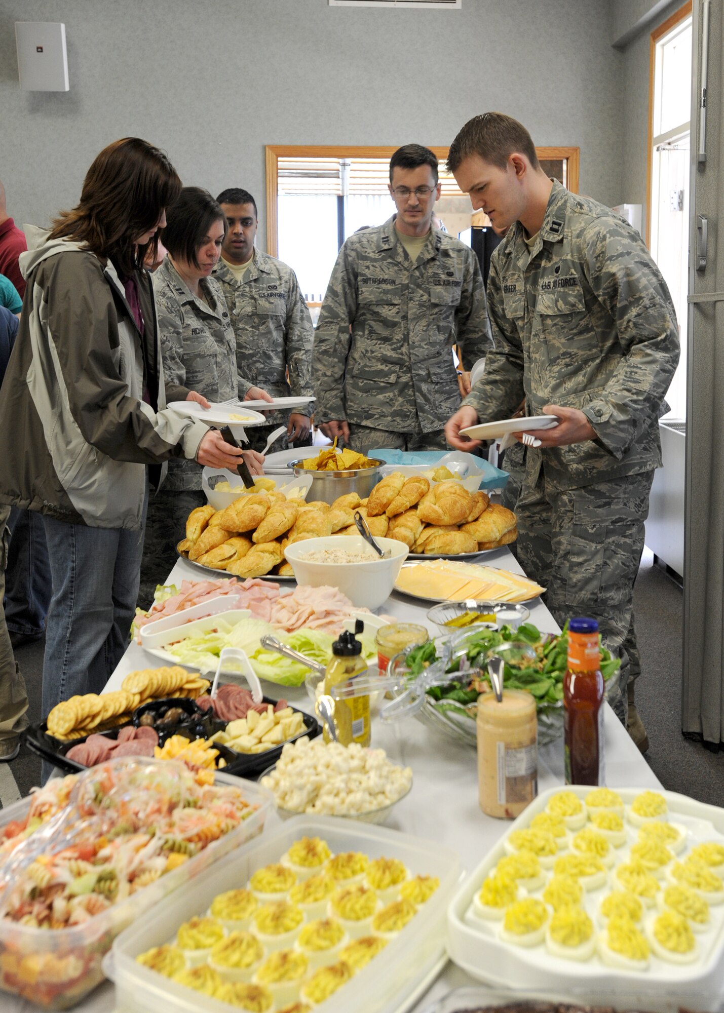 McConnell Airmen go through a buffet line at the base chapel during the Sexual Assault Awareness month luncheon April 30, 2010, McConnell Air Force Base, Kan.  Nationally, Sexual Assault Awareness month is observed in April and is utilized as a time to raise awareness and promote the prevention of sexual violence. Attendees of the luncheon were McConnell community partners Wichita Area Sexual Assault Center, Via Christi St. Joseph Sexual Assault Nurse Examiners and Team McConnell’s Sexual Assault Response Team. (U.S. Air Force photo/Airman 1st Class Andrea Salazar)