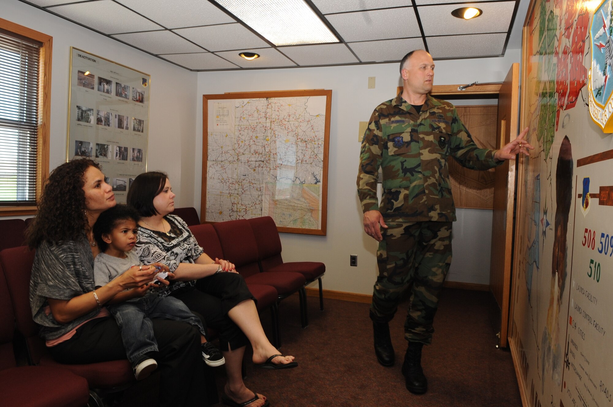 WHITEMAN AIR FORCE BASE, Mo. - Tech. Sgt. Phillip Flemming, 509th Bomb Wing History Office, points out where different launch control facilities used to be to Cheryl Dodson and Ursula Martin, Air Force widows, and Guahan Martin, Mrs. Martin's son, during a tour of OSCAR-1,  a deactivated launch control facility, May 4, 2010. Their husbands, Col. George Martin, 36th Medical Group deputy commander and Capt. Michael Dodson, Air Force pilot, perished in a B-52 crash off the coast of Guam July 21, 2008. (U.S. Air Force photo/Senior Airman Stephen Linch) 
