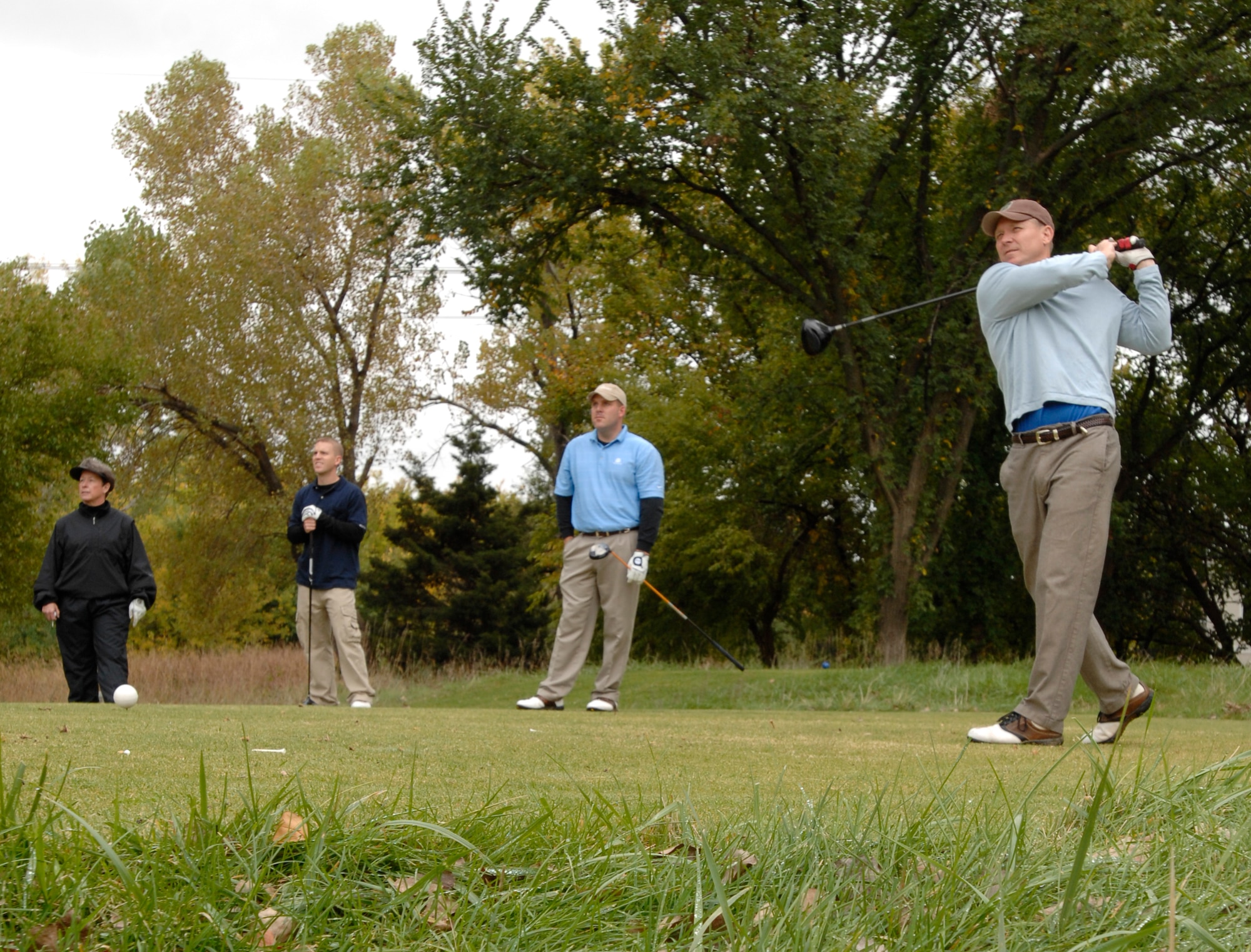 Col. Bart Weiss, 22nd Air Refueling Wing vice commander, tees off at the Tallgrass Golf Course while his team-mates watch during the VIP Golf Tournament Oct. 12, 2009, Wichita, Kan. More than 45 Team McConnell Airmen and local community leaders played in the 18-hole event consisting of 12 teams with four players each.  Col. Weiss’ team placed first in the event. (U.S. Air Force photo/Senior Airman Laura Suttles)