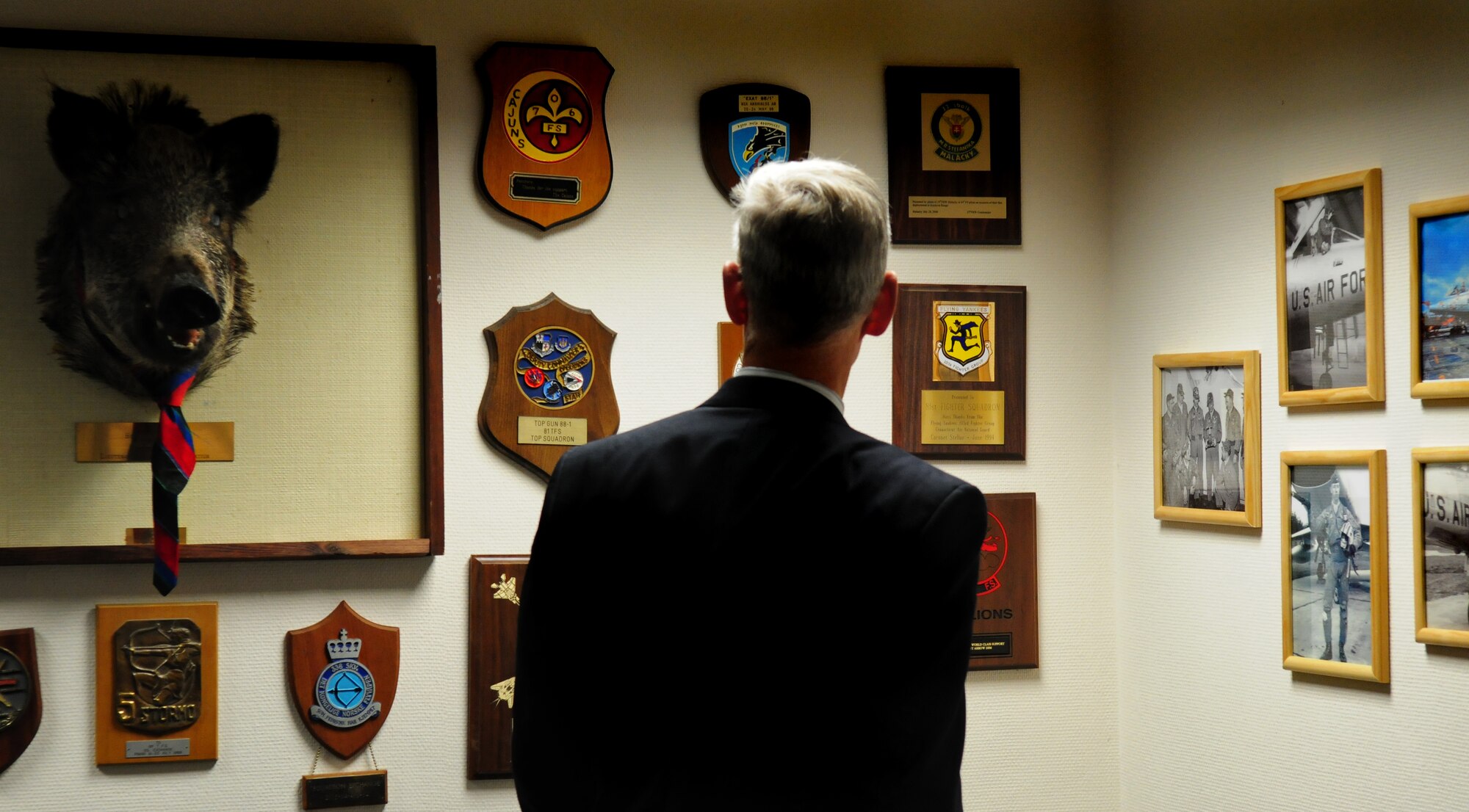 SPANGDAHLEM AIR BASE, Germany -- Retired Maj. Gen. Peter Robinson, former 36th Tactical Fighter Wing commander, observes photographs in the 81st Fighter Squadron heritage room during a visit May 5.  General Robinson was first assigned as a fighter pilot to the 81st FS and later served as the commander of Bitburg Air Base prior to its closure.  (U.S. Air Force photo/Staff Sgt. Heather M. Norris)