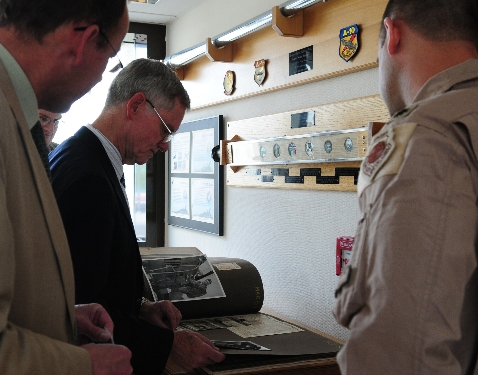 SPANGDAHLEM AIR BASE, Germany -- Retired Maj. Gen. Peter Robinson, former 36th Tactical Fighter Wing commander, looks through a photo album at the 81st Fighter Squadron during a visit May 5.  General Robinson was first assigned as a fighter pilot to the 81st FS and later served as the commander of Bitburg Air Base prior to its closure.  (U.S. Air Force photo/Staff Sgt. Heather M. Norris)
