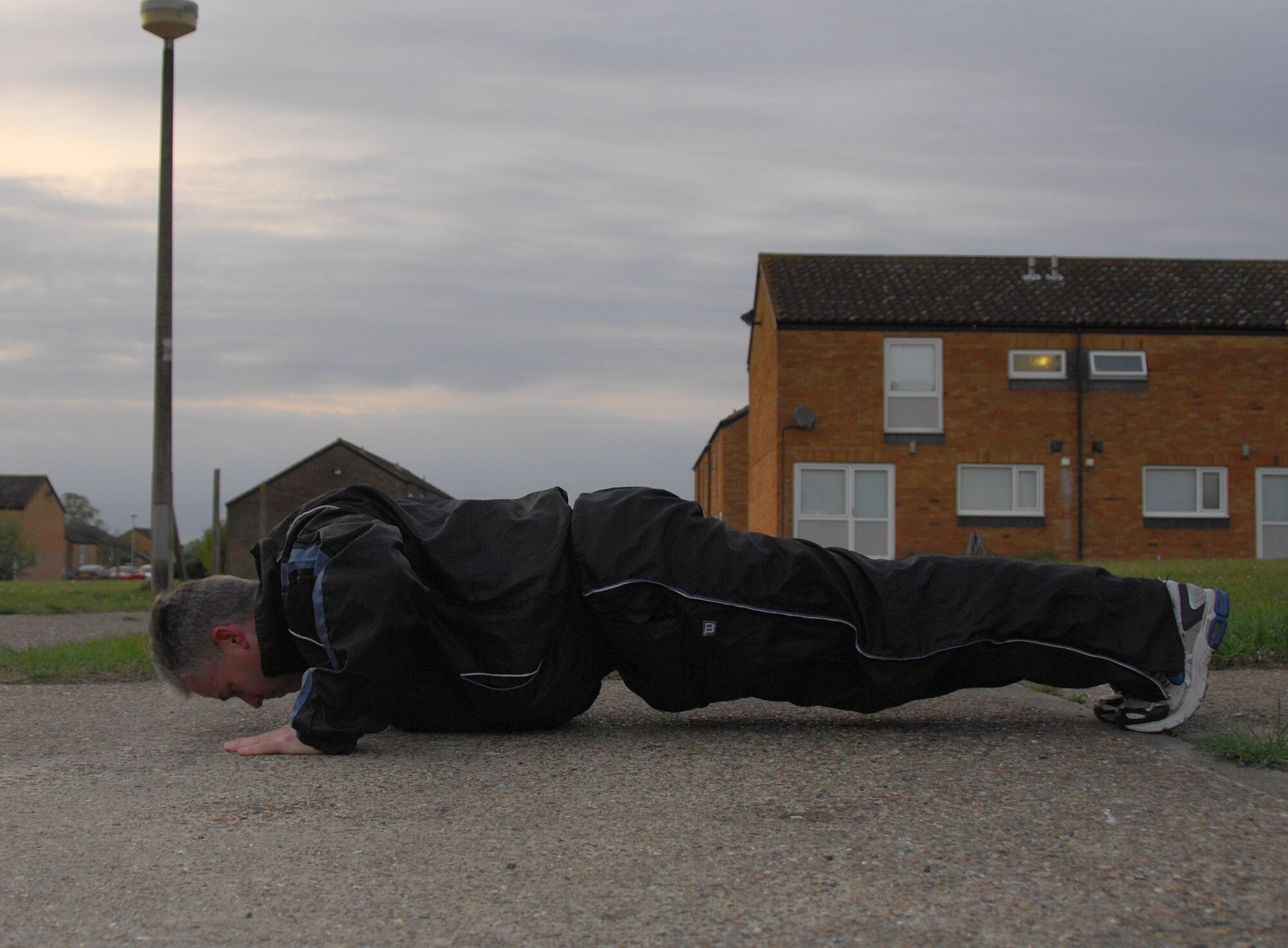 Tech. Sgt. Christopher A. Campbell, 48th Fighter Wing Public Affairs NCOIC of Internal operations demonstrates his push-up form outside his residence at RAF Lakenheath May 5. Sergeant Campbell continues to work at his form after undergoing surgeries to both  his shoulders. (U.S. Air Force photo/Alexander Campbell)
