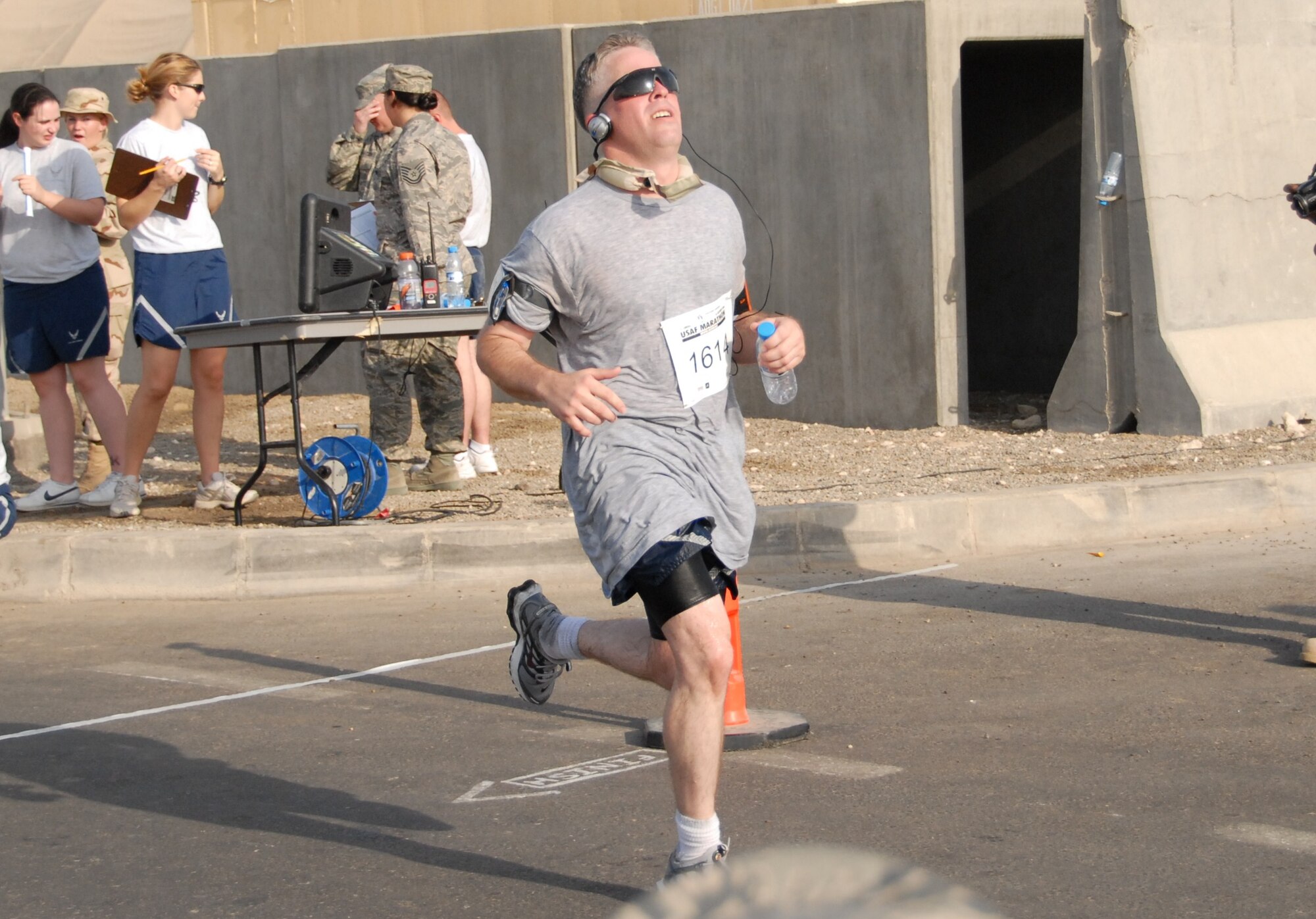 Tech. Sgt. Christopher A. Campbell, 380th Air Expeditionary Wing photographer, crosses the finish line Sept. 27, 2008, in Southwest Asia. He finished a half marathon, more than thirteen miles in two hours. Sergeant Campbell’s favorite hobby is running. He had to take a break from running due to shoulder problems, but after two surgeries, Sergeant Campbell is back on the roads. (U.S. Air Force photo/Tech. Sgt. Denise Johnson)