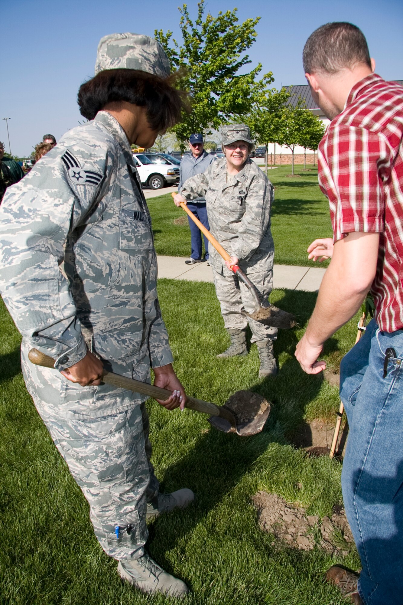 GRISSOM AIR RESERVE BASE, Ind. -- Col. Betty Bowen, Senior Airman Jamia Nalls and Cory Walters prepare to dump shovels of dirt into the hole of a tree they just planted during an Arbor Day ceremony held here recently. Because of Grissom's dedication to maintaining the urban forest and the environment, the base was recently named a Tree City USA for the ninth straight year by the National Arbor Day Foundation. Colonel Bowen is the 434th Mission Support Group commander and Airman Nalls and Mr. Walters are with the 434th Civil Engineer Squadron. (U.S. Air Force photo/Tech. Sgt. Mark R. W. Orders-Woempner)