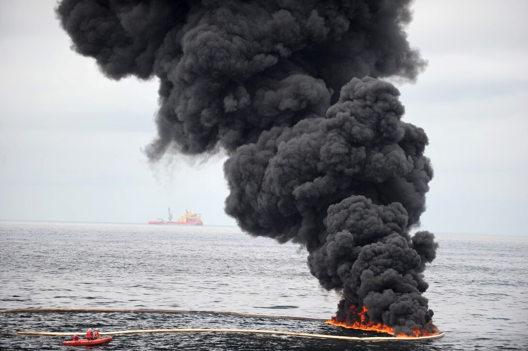 Smoke billows over a controlled oil fire in the Gulf of Mexico off Venice, La., May 5, 2010. The U.S. Coast Guard, working with BP, local residents and federal agencies, conducted the burn to help prevent the spread of oil following the April 20 explosion on Deepwater Horizon, an offshore drilling unit.