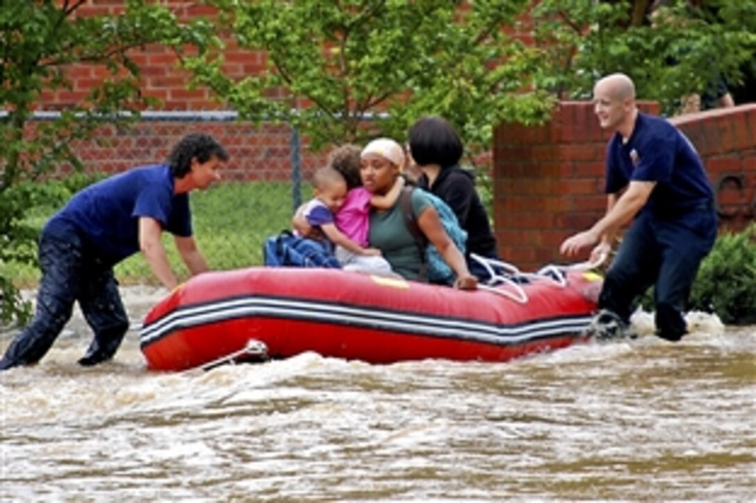 Fire rescue personnel evacuate family members from base housing at Naval Support Activity Mid-South, Millington, Tenn., May 1, 2010. Two days of rain dumped more than 14 inches in the area, causing a drainage ditch on the east side of the base to spill over and flood parts of the base.