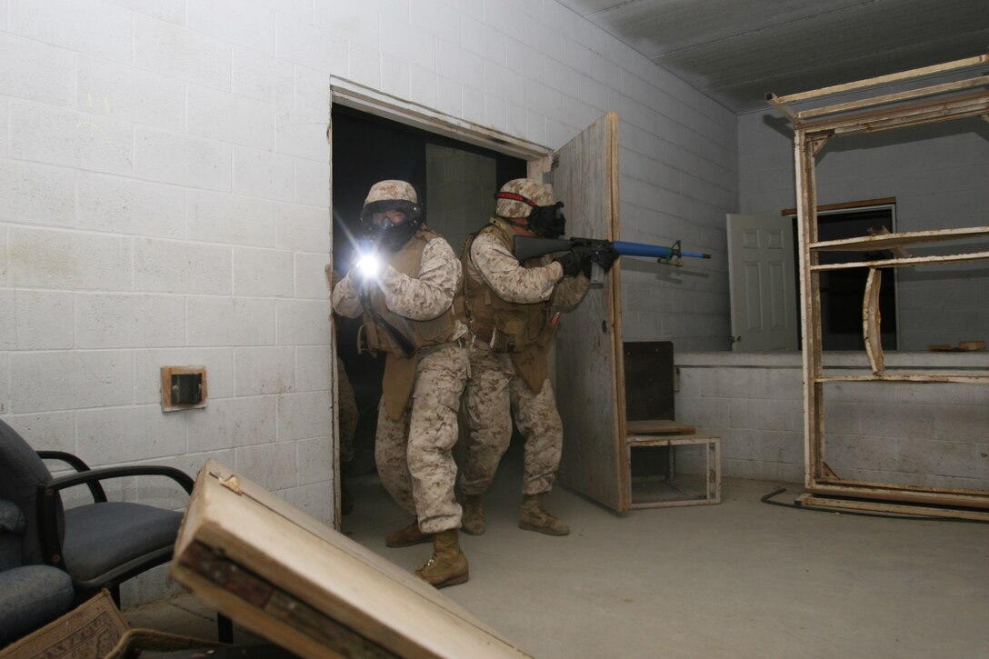 Marines from Headquarters and Ser¬vice Company, 7th Engineer Support Battalion, 1st Marine Logistics Group enter a house during a training exercise at Marine Corps Base Camp Pendle¬ton, Calif., May 6.