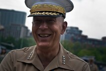 Gen. James T. Conway, commandant of the Marine Corps hears a joke from a Marine manning a static display at Boston Common May 6, 2010. Conway visited Marines who have been interacting with Bostonians during Marine Week May 3-9 to thank them for their hard work and Bostonians for their support of the men and women in uniform.