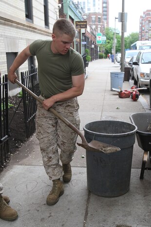 Cpl. Timothy Brukner, a rifleman of 3rd Battalion, 24th Marines, Johnson City, Tenn., spreads fresh mulch in front of the Brook House in Boston in support of Marine Week Boston, May 6, 2010. The Brook House is used as local adult pre-release facility.