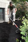 Marines of 3rd Battalion, 24th Marines, Johnson City, Tenn., spread fresh mulch and plant new flowers in front of the Brook House in Boston in support of Marine Week Boston, May 6, 2010. The Brook House is used as local adult pre-release facility.
