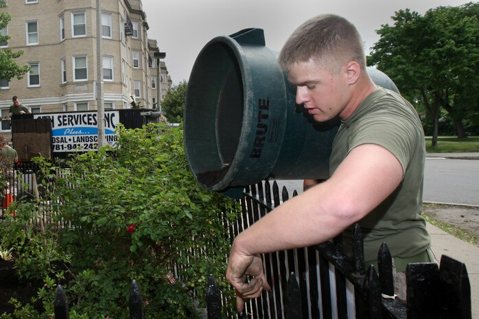 Cpl. Timothy Bruckner, a rifleman of 3rd Battalion, 24th Marines, Johnson City, Tenn., spreads fresh mulch and plants new flowers in front of the Brook House in Boston in support of Marine Week Boston, May 6, 2010. The Brook House is used as local adult pre-release facility.