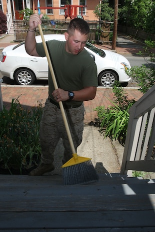 Lance Cpl. Mark Whitehead-Rozar of 3rd Battalion, 24th Marines, Johnson City, Tenn., sweeps the front porch in an effort to help renovate the Robert J. Watson House, in Cambridge, Mass., in support of Marine Week Boston, May 6, 2010. Once Renovated, the Robert J. Watson House will be used as a shelter for troubled youth females.