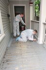 Cpl. Seth Lane (left) and Lance Cpl. Dustin Humphreys (right) of 3rd Battalion, 24th Marines, Johnson City, Tenn., paint the front porch in an effort to help renovate the Robert J. Watson House, in Cambridge, Mass., in support of Marine Week Boston, May 6, 2010. Once Renovated, the Robert J. Watson House will be used as a shelter for troubled youth females.