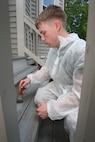 Lance Cpl. Nathan Jones of 3rd Battalion, 24th Marines, Johnson City, Tenn., paints the front porch in an effort to help renovate the Robert J. Watson House, in Cambridge, Mass., in support of Marine Week Boston, May 6, 2010. Once Renovated, the Robert J. Watson House will be used as a shelter for troubled youth females.