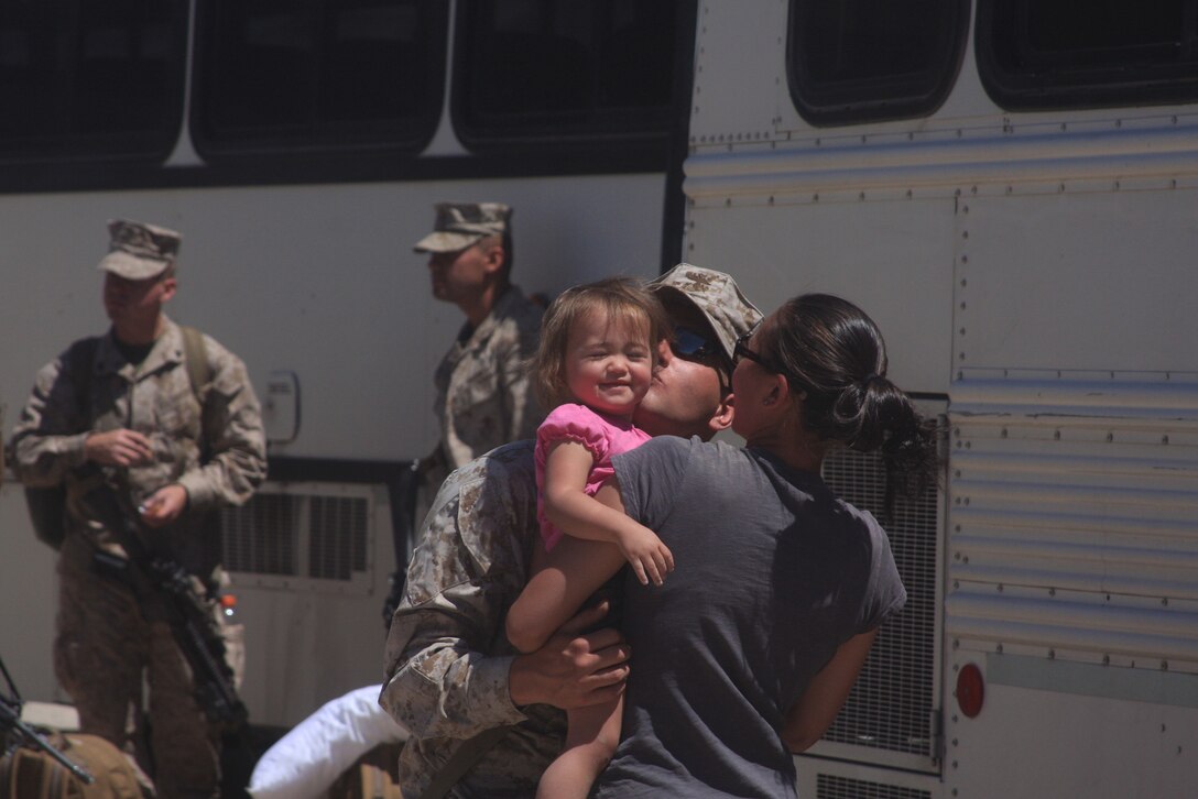 Sgt. Neil Grone, the operations chief with Battery L, 3rd Battalion, 11th Marine Regiment, says goodbye to his wife, Jessica, and daughter, Kayleigh, as Marines board buses and head out for a seven-month deployment in support of Operation Enduring Freedom May 7.
