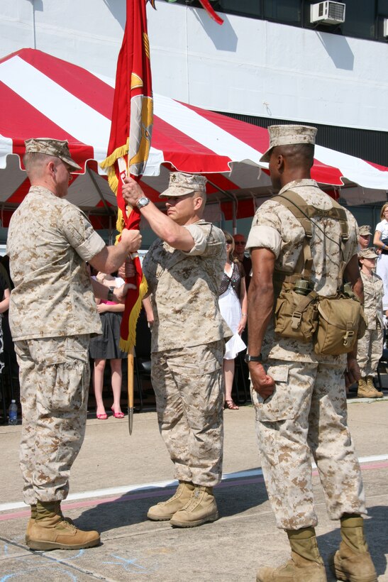 Lt. Col. James F. Harp relinquishes command of Marine Heavy Helicopter Squadron 366, May 7. Harp passes the squadron’s colors to the new commanding officer, Lt. Col. Halstead Meadows outside HMH-366’s hangar. ::r::::n::“A lot has been accomplished by these Marines’ hard work over the past 19 months, and I give them the credit,” said Harp.::r::::n::