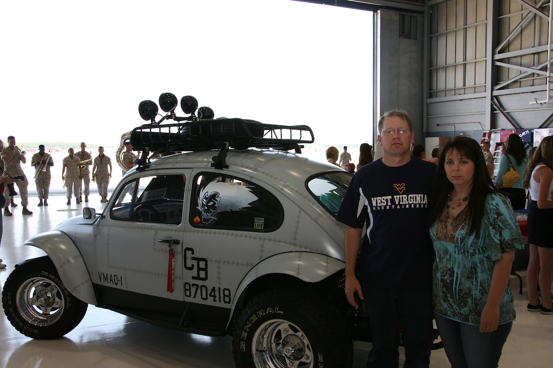 Husband and wife, Andy and Kelly J. Collison, parents of the late Cpl. Buddy Collison, formerly with Marine Tactical Electronic Warfare Squadron 1, stand next to a 1969 Volkswagen Baja Bug, which they refurbished inside and out to emulate an EA-6B Prowler. The Collisons restored the Bug to commemorate their son, who died in a car accident last year.