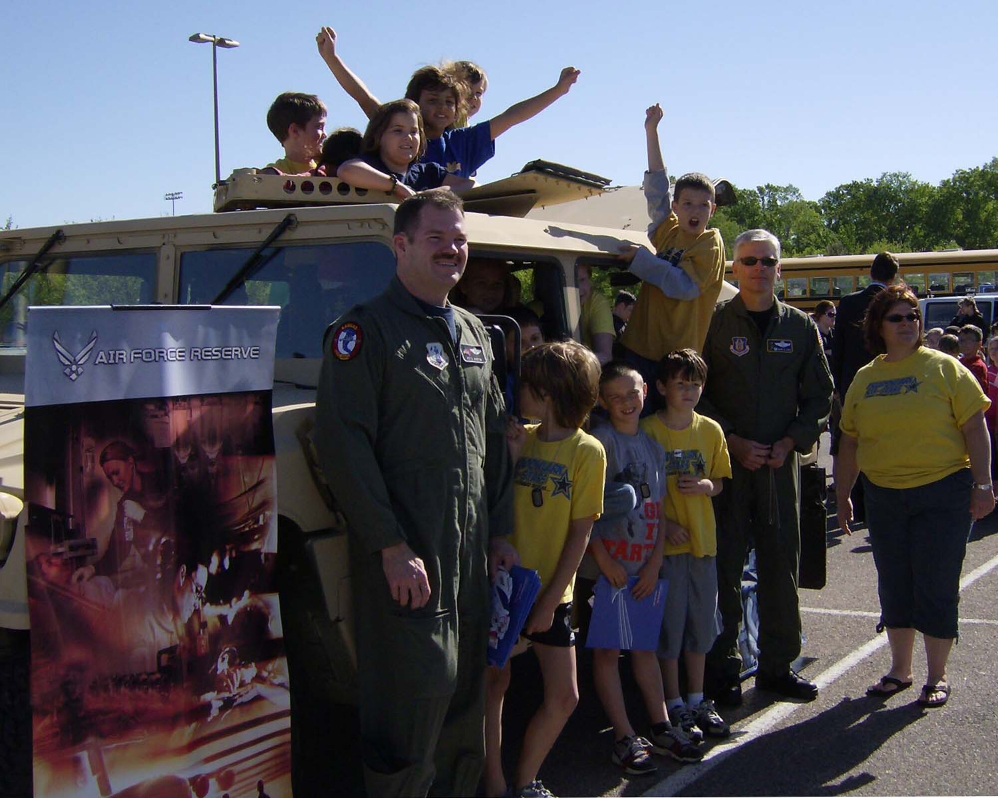 Lt. Col. Peter Austin, 184th Operations Support Squadron director of operations,184th Intelligence Wing, Kansas Air National Guard and Lt. Col. Barry Jones, 931st Operations Support Flight commander, 931st Air Refueling Group take a moment to pose for a picture with students during the Careers on Wheels Days for thrid graders in the Andover elementary school system on May 4.