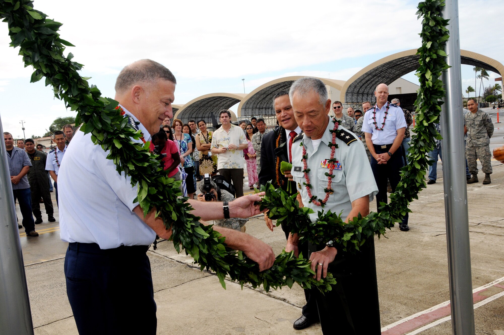 Gen. Gary L North, PACAF commander and Maj. Gen. Robert G.F. Lee, Hawaii adjutant general untie maile lei as part of the ground breaking ceremony for the F-22 Low Observable Composite Repair Facility on Hickam Air Force Base, Hawaii. The Hawaii Air National Guard is replacing their F-15 Eagles with the F-22 Raptor. The HIANG is scheduled to receive their first F-22 in July. (U.S. Air Force Photo/Master Sgt. Kristen Stanley)
