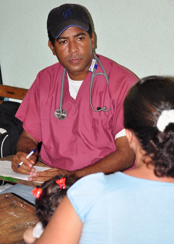 Doctor Miguel Coello, Joint Task Force-Bravo Medical Element physician evaluates a patient and her daughter during the Nicaragua medical civic action program May 4 in El Ayote, Nicaragua. More than 25 American, Nicaraguan and Honduran medical professionals provided healthcare to 1,100 residents in and around the town. (U.S. Air Force photo by Staff Sgt. Bryan Franks)