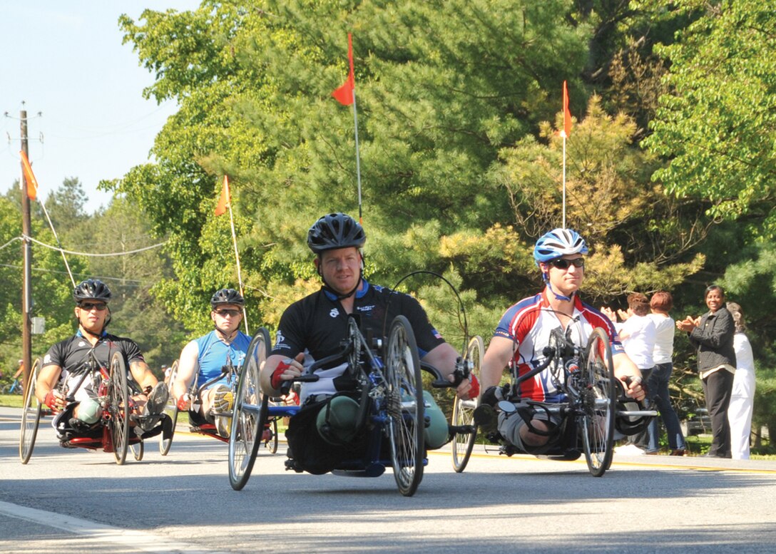 The first wave of wounded warrior cyclists receive cheers of encouragement as they roll past an audience of Joint Base Andrews, Md., members during the Wounded Warrior Ride. More than 30 veterans from around the country who have been injured in combat biked from Andrews to Annapolis, Md., on April 30, 2010. This was the second time The Wounded Warrior Project’s Soldier Ride has stopped at Andrews. The Wounded Warrior Project is a nonprofit organization that advocates for the needs of veterans injured in combat. (U.S. Air Force photo by Bobby Jones)