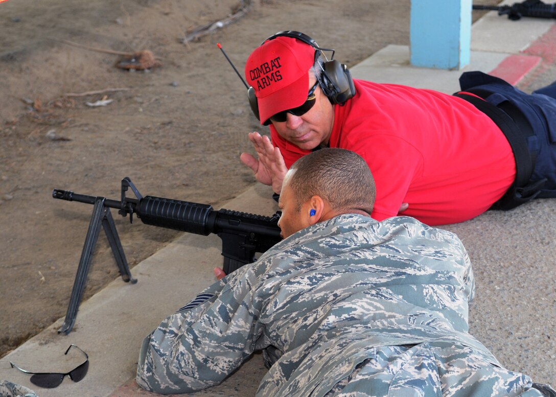 Tech Sgt. Leslee Williams of the 61st Security Forces Squadron sights his M-4 carbine while Officer Mark Tuttle, a 61 SFS combat arms instructor, provides feedback. Sergeant Williams is part of the 61 SFS team competing in this year's Guardian Challenge May 16 through 19 at the Air Force Space Command in Colorado Springs, Colo. (Photo by Jim Gordon)