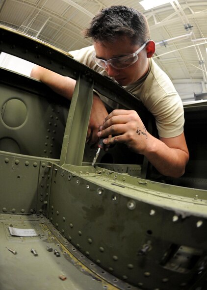 DYESS AIR FORCE BASE, Texas -  Airman 1st Class Christopher Greene, 7th Equipment Maintenance Squadron, repairs a C-130 Hercules cargo ramp May 6 here. Airman Greene provides support for both the B-1 Bomber and C-130, insuring they are structurally sound and mission ready. (U.S. Air Force photo/ Airman 1st Class Chelsea Browning)