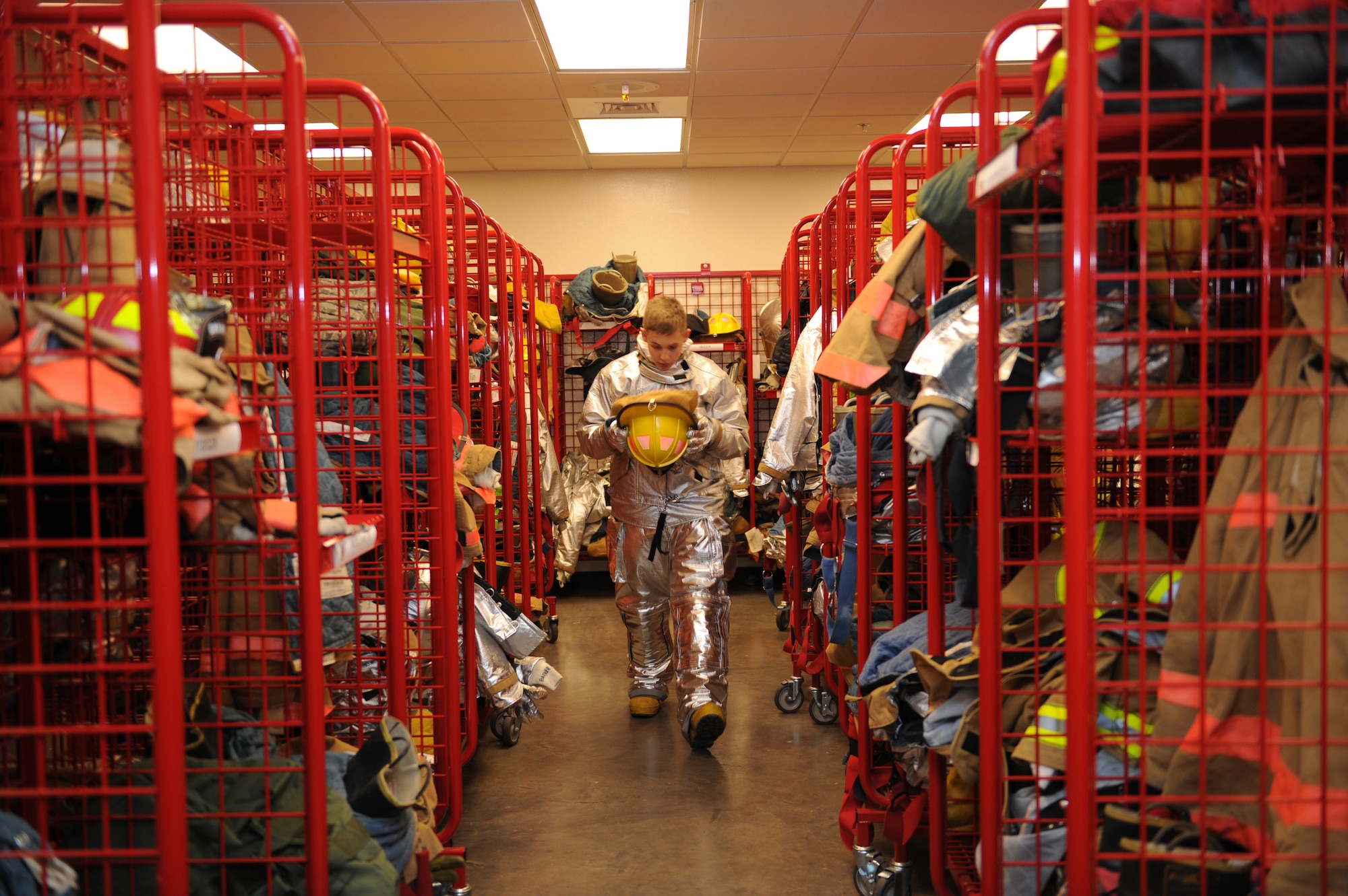 DYESS AIR FORCE BASE, Texas-- Airman 1st Class Jacob Strachan, 7th Civil Engineer Squadron firefighter, dons his fire-prevention gear May 6 here.  There are more than 55 firefighters within the squadron who operate more than 15 fire trucks. Some days they have up to 10 calls and are required to be on scene within five minutes of the call. Firefighters keep everyone on the base as safe as possible by conducting routine safety checks on the buildings as well as practicing what to do in case of a fire.  (U.S Air Force photo/ Airman 1st Class Shannon Hall)
