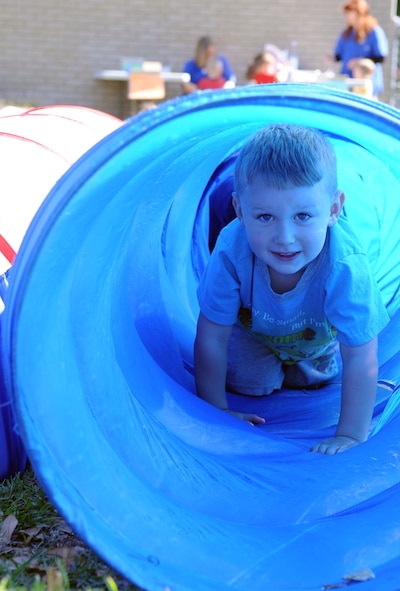 BARKSDALE AIR FORCE BASE, La. -- Sean Hudgeons, 3, crawls through a tunnel during the Military Child Carnival held at the Barksdale Child Development Center April 29. This event was held in support of the National Month of the Military Child. Sean is the son of Staff Sgts. John and Maria Hudgeons, 2d Comptroller Squadron. (U.S. Air Force photo by Senior Airman La’Shanette V. Garrett) (RELEASED)